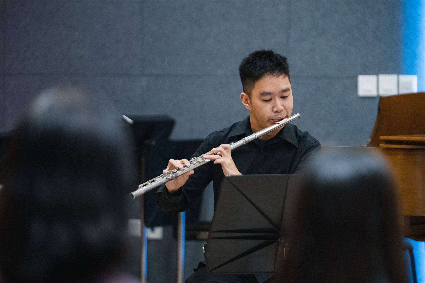 A King's Flute Choir musician playing the concert flute