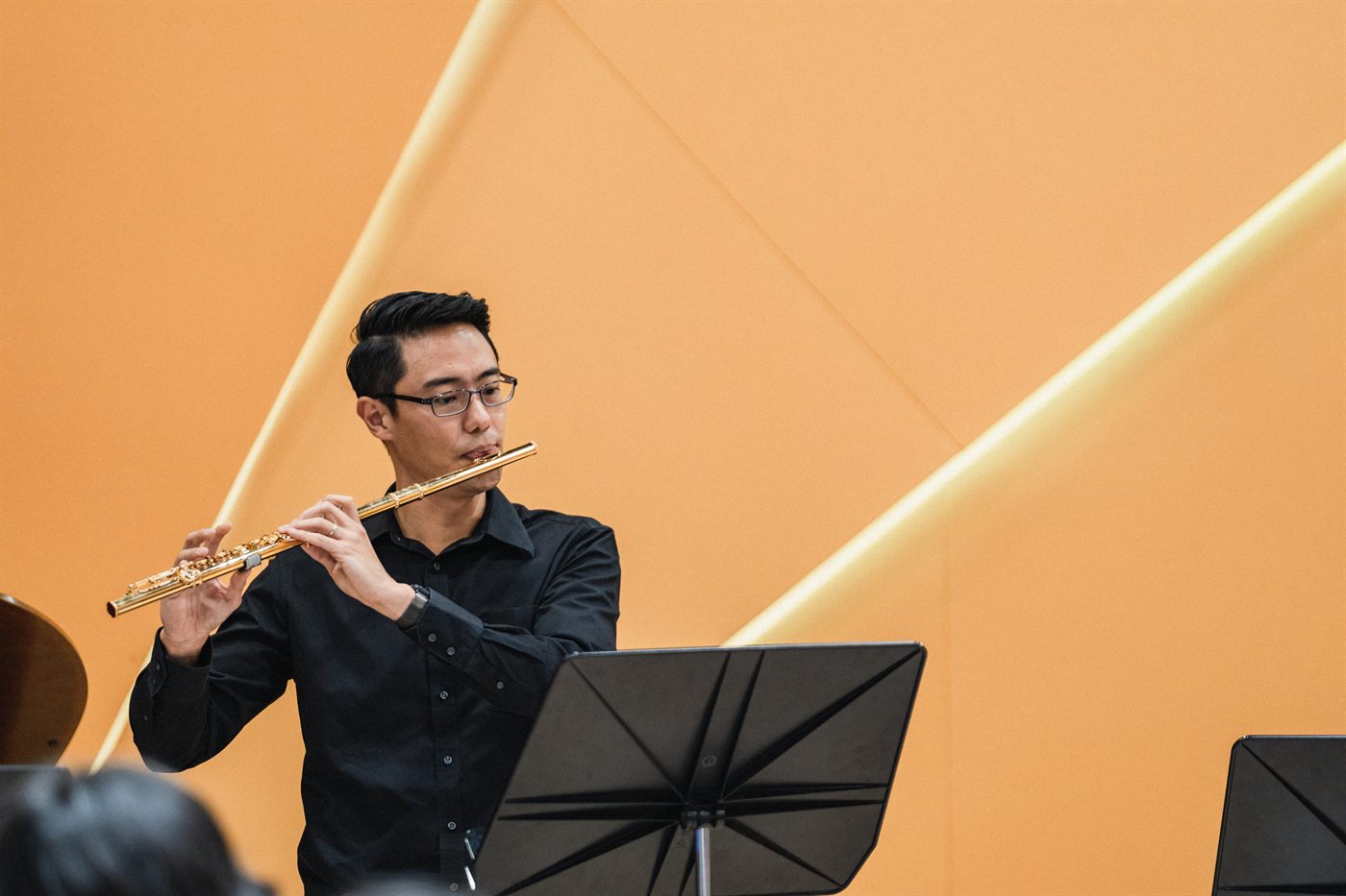 A King's Flute Choir musician playing a gold flute